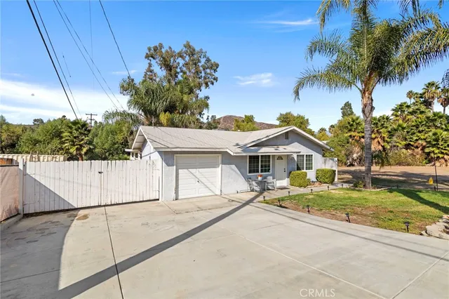 a white house that has a tree in front of it