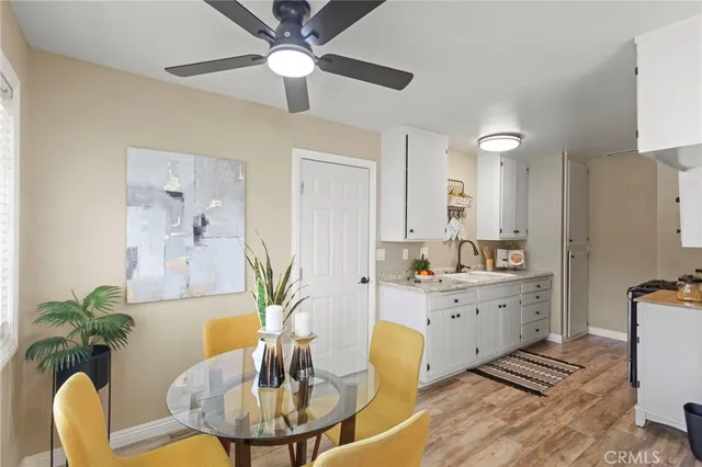 a living room with furniture potted plant and a chandelier