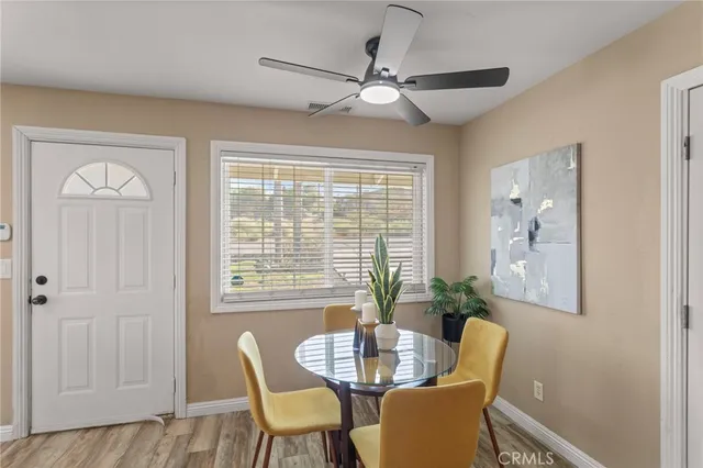 a dining room with furniture and window