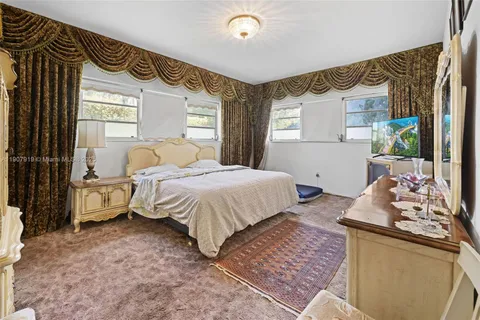 a bedroom with a bed and a mirror