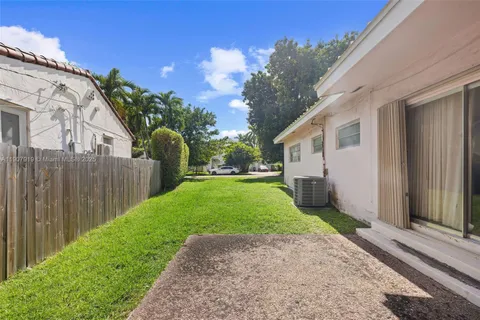 a view of a house with backyard and a garden