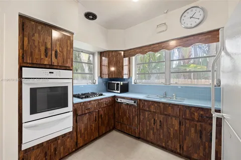 a kitchen with a stove oven and a sink