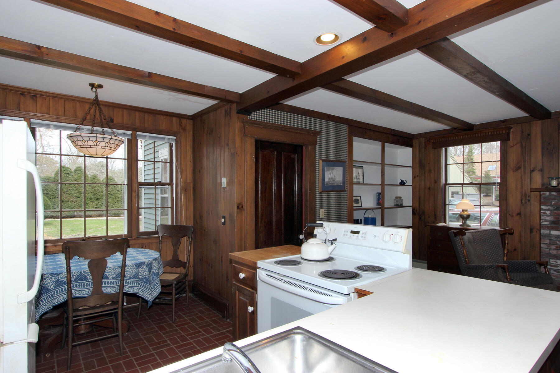 220 Locust Road Eastham, MA 02642 - Photo 11 of 50 a living room with furniture a table and large windows