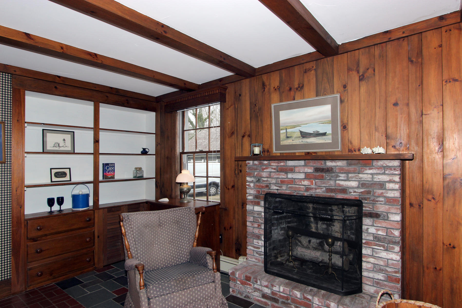 220 Locust Road Eastham, MA 02642 - Photo 12 of 50 a living room with furniture a window and a fireplace