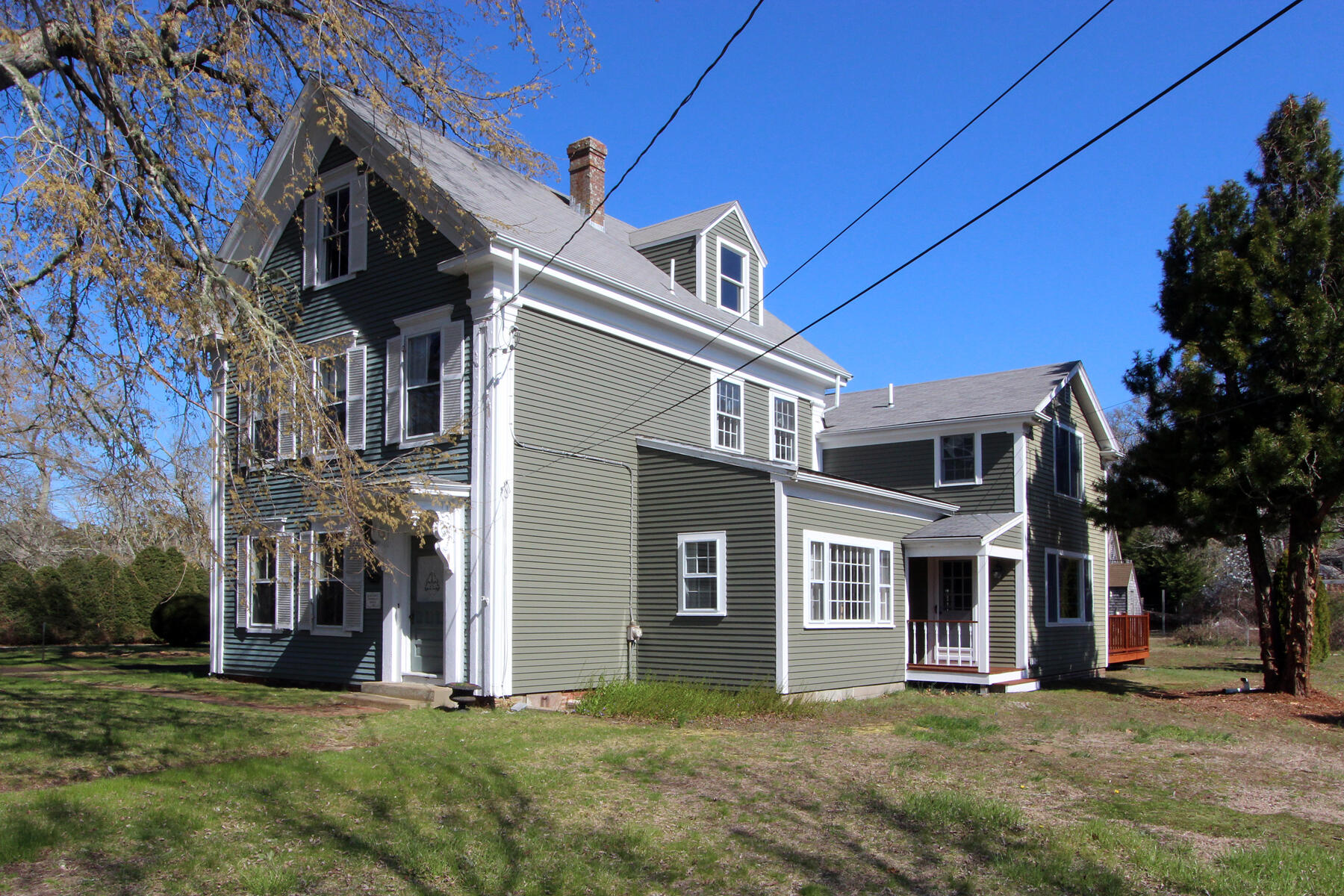 220 Locust Road Eastham, MA 02642 - Photo 3 of 50 a view of a house with a big yard and large trees