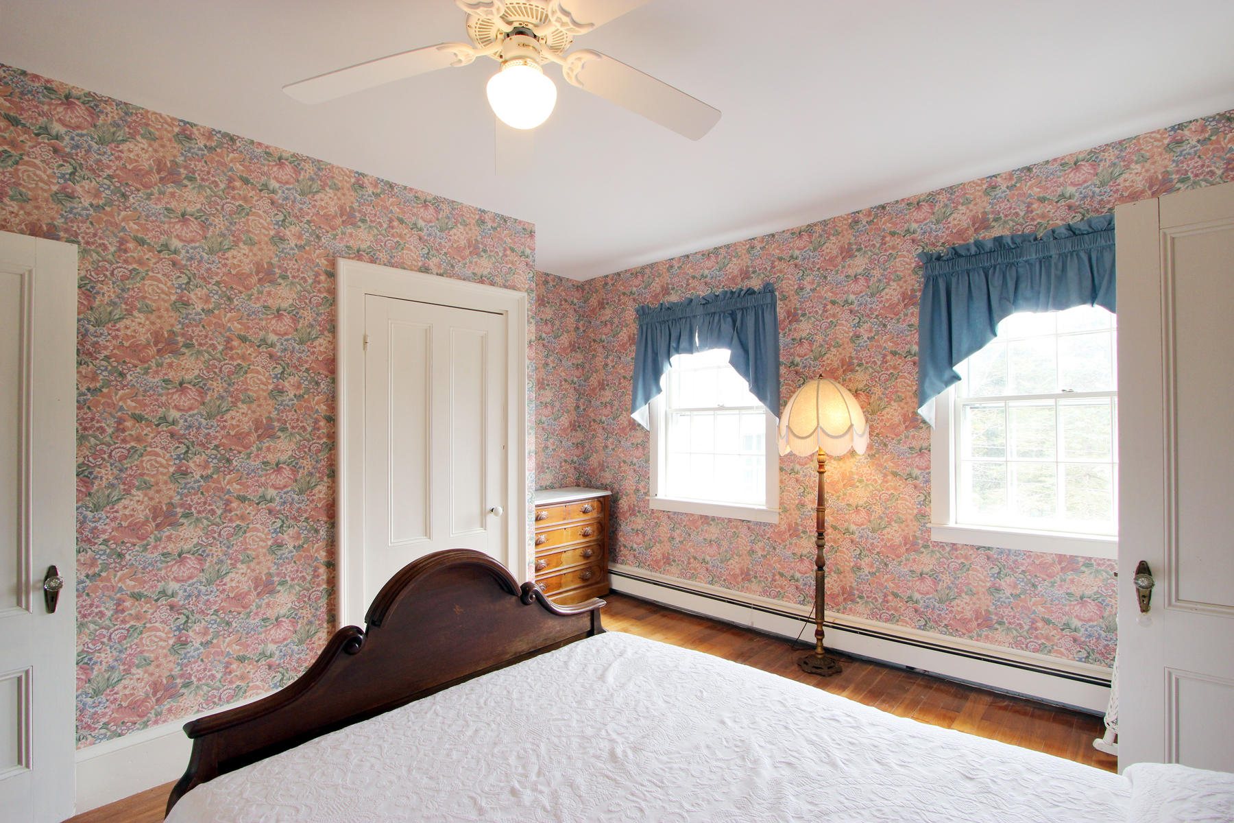 220 Locust Road Eastham, MA 02642 - Photo 32 of 50 a bedroom with a bed and a chandelier