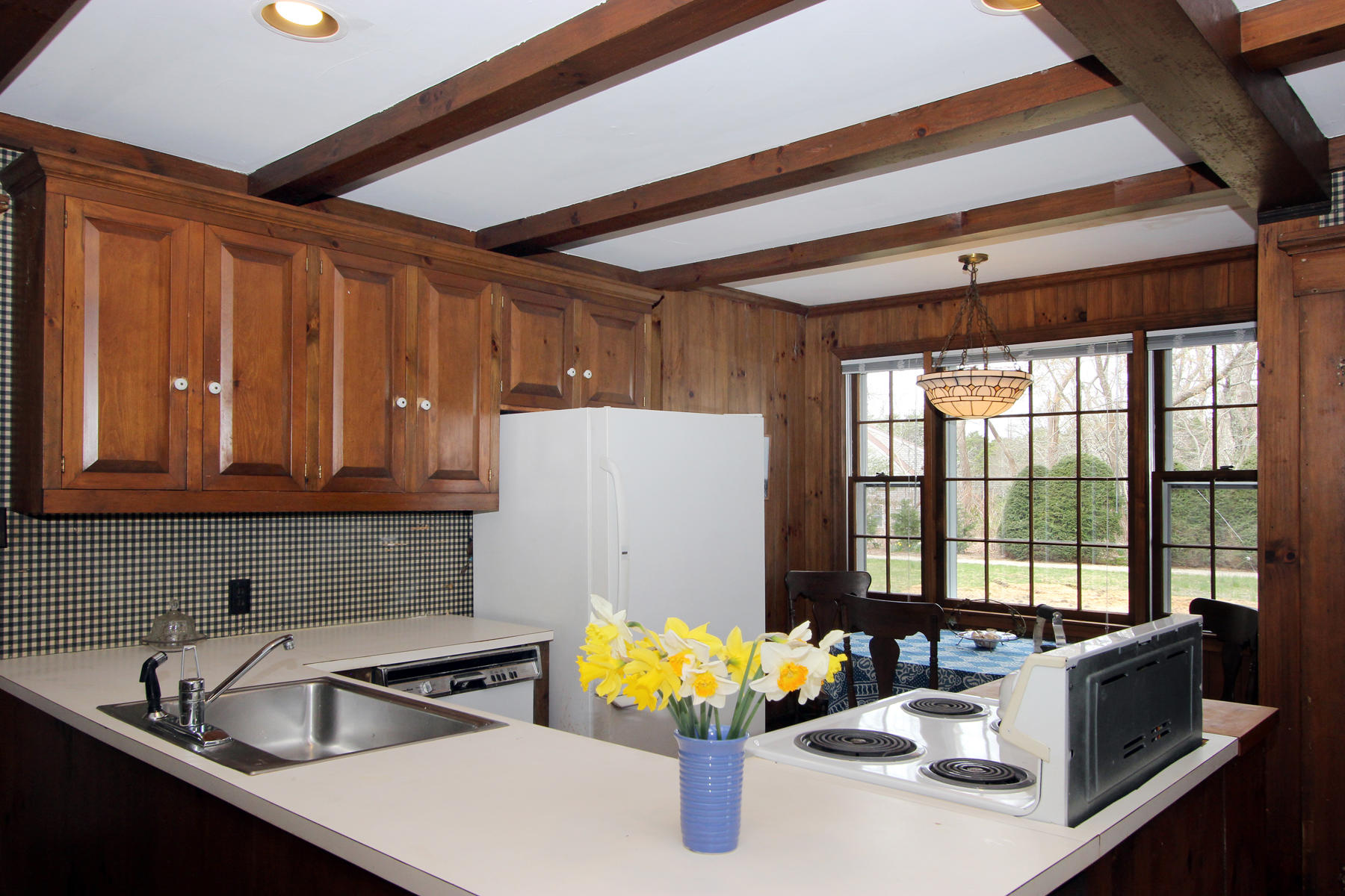 220 Locust Road Eastham, MA 02642 - Photo 8 of 50 a kitchen with sink refrigerator and window