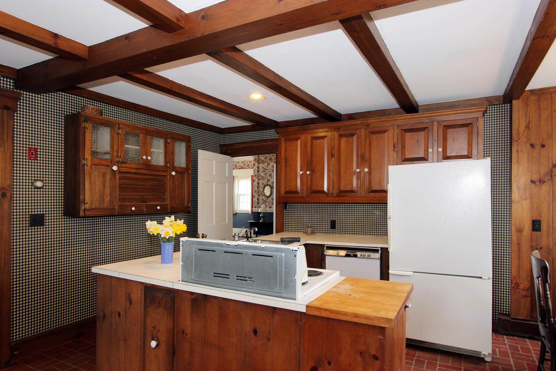 220 Locust Road Eastham, MA 02642 - Photo 9 of 50 a kitchen with a sink a refrigerator and wooden cabinets