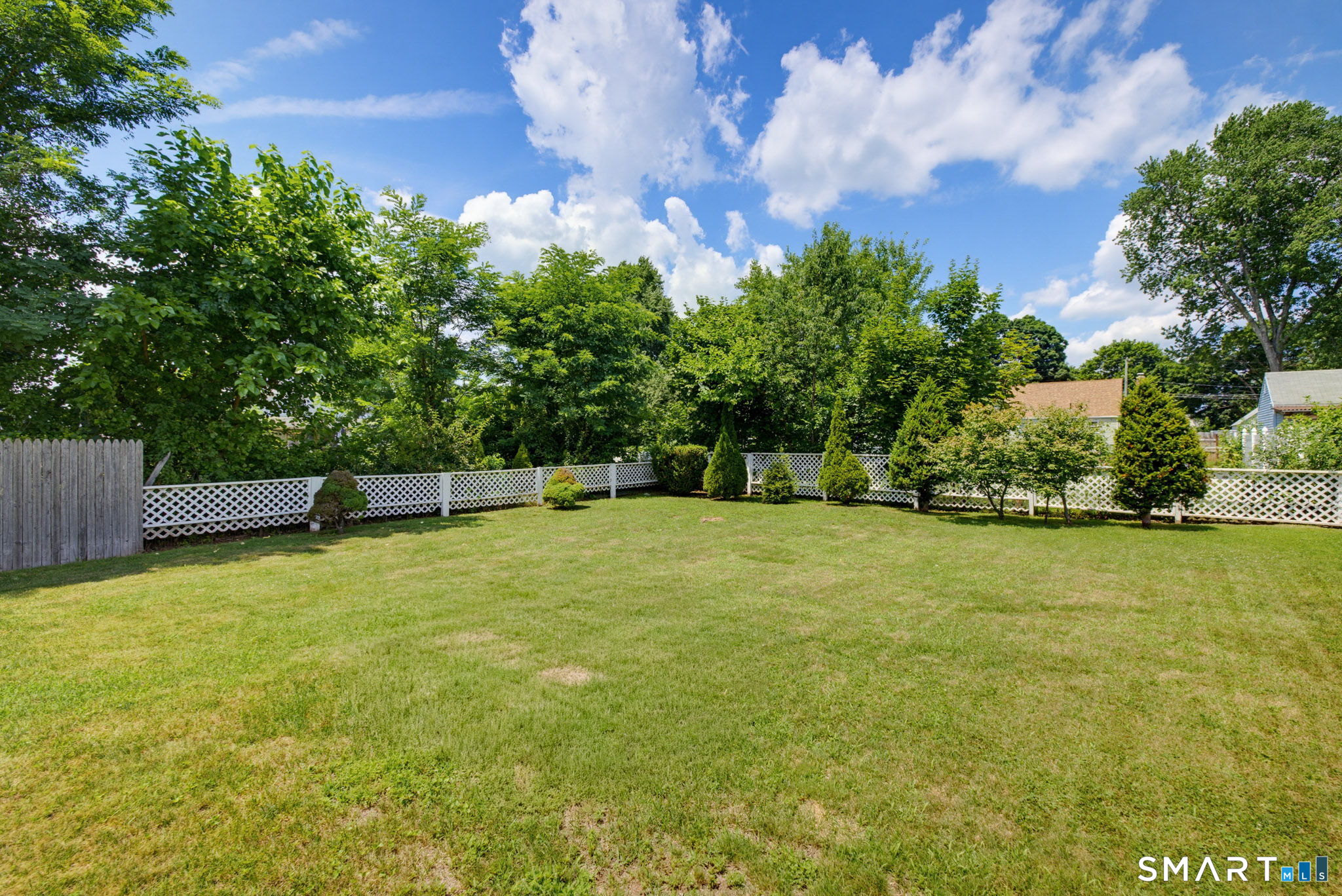 417 Hartford Road Manchester, CT 06040 - Photo 5 of 38 Beautiful back yard with trees and fencing for added privacy in back yard.