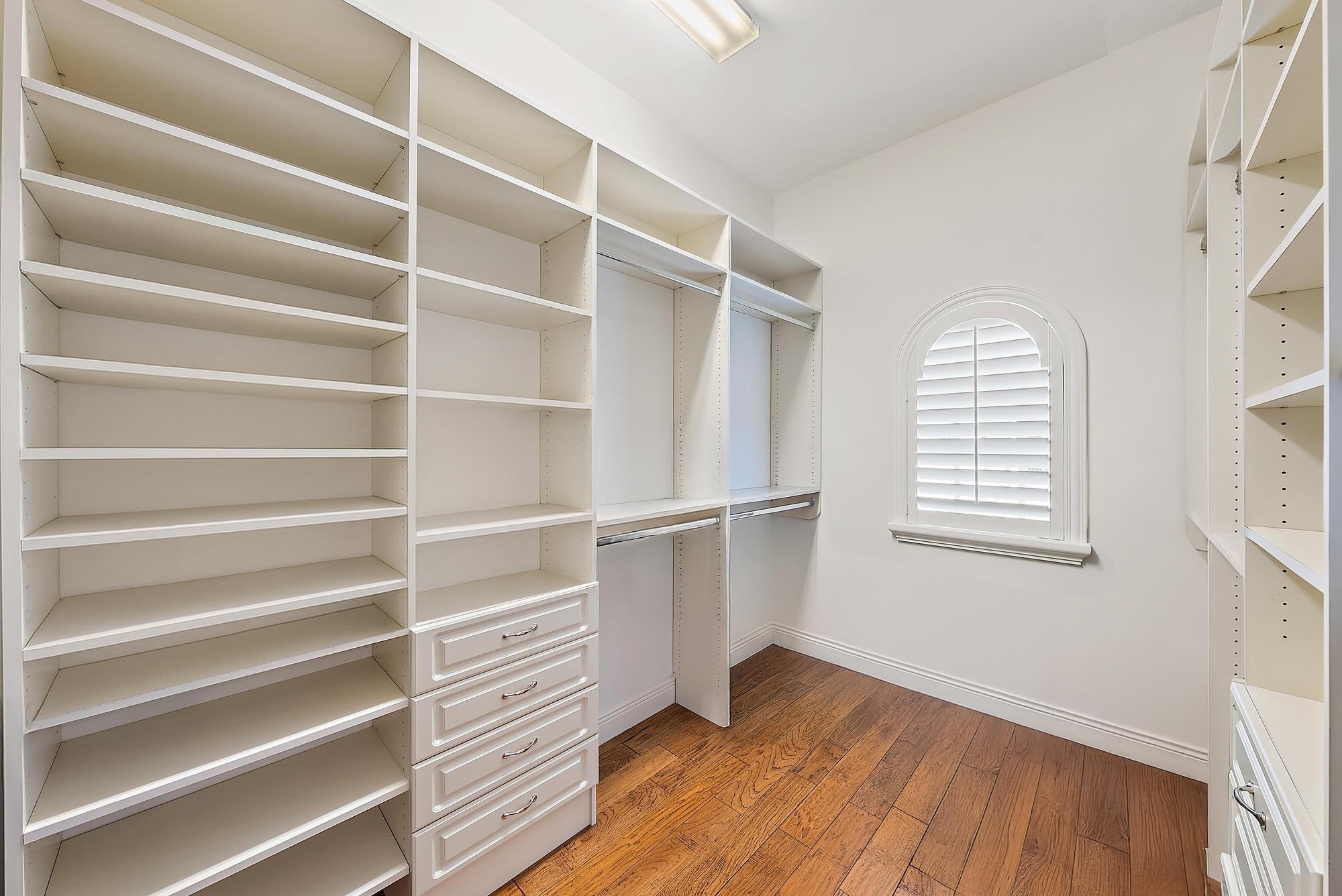 126 Tierra Lane, Unit 2 Jupiter, FL 33477 - Photo 42 of 59 a view of an empty room with a window and wooden floor