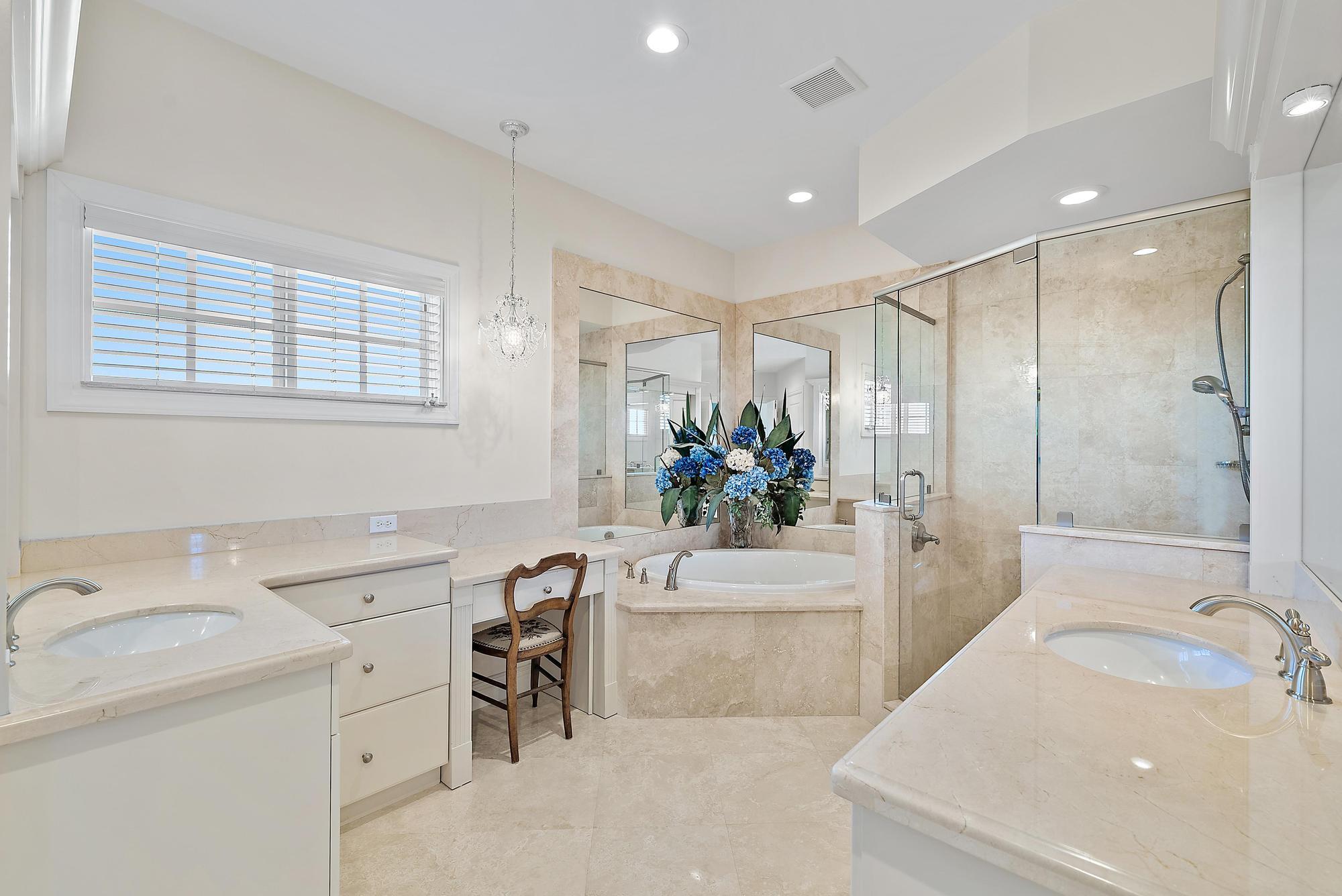 126 Tierra Lane, Unit 2 Jupiter, FL 33477 - Photo 43 of 59 a spacious bathroom with a sink and a bathtub