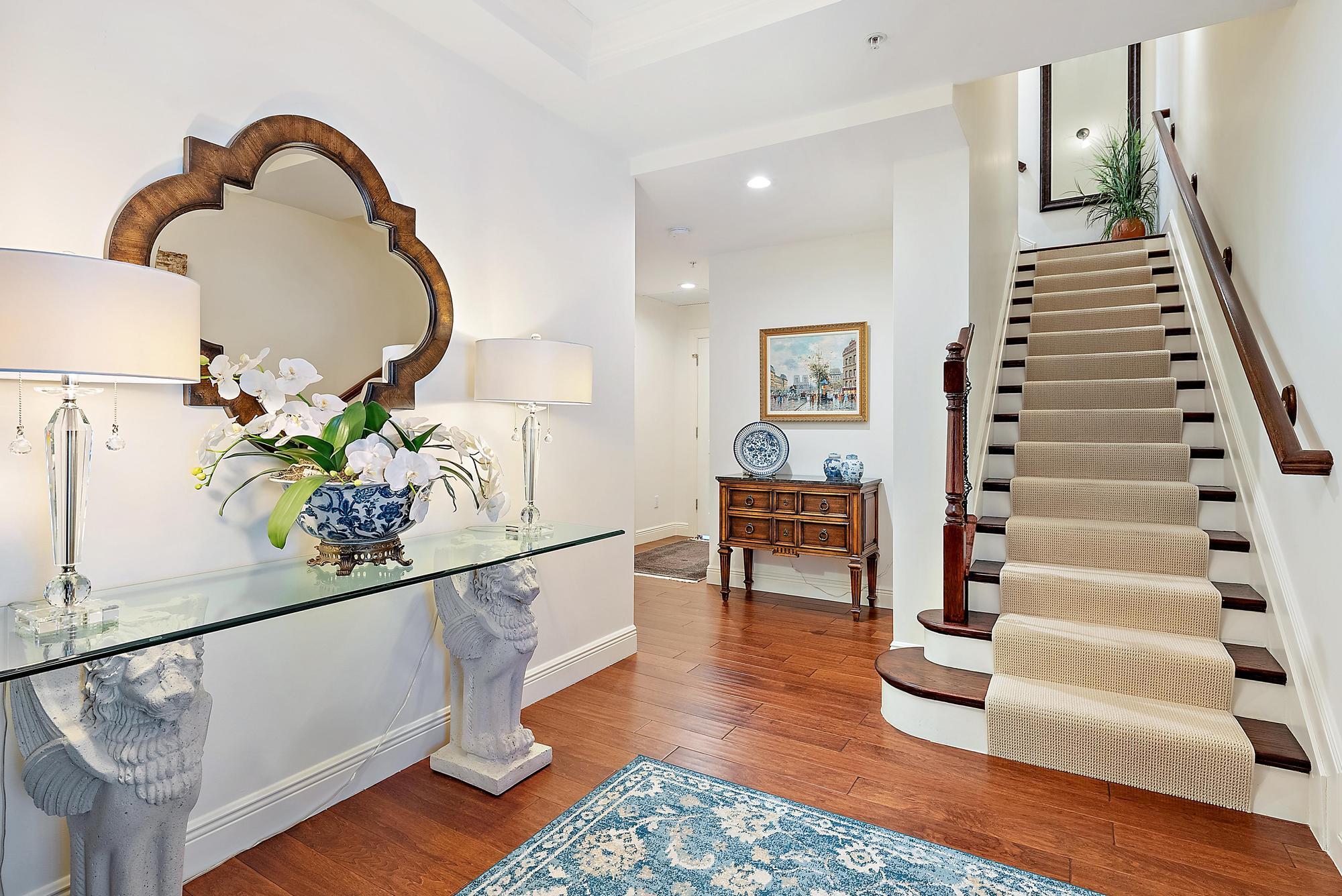 126 Tierra Lane, Unit 2 Jupiter, FL 33477 - Photo 6 of 59 a view of entryway and hall with wooden floor