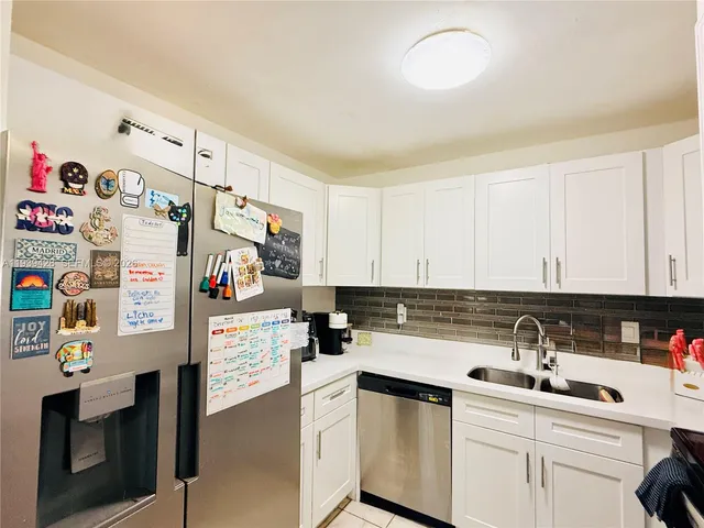 a kitchen with refrigerator and cabinets