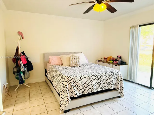 a bedroom with a bed and painting on the wall