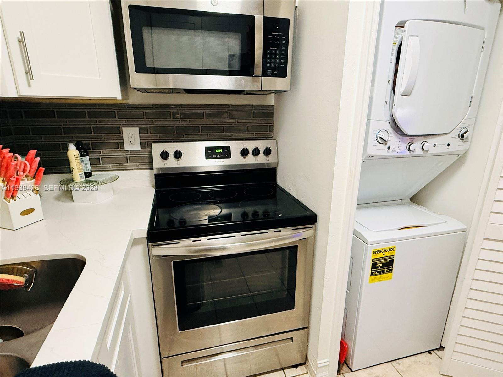 2651 Riverside Drive, Unit 3 Coral Springs, FL 33065 - Photo 13 of 29 a kitchen with a stove and a microwave