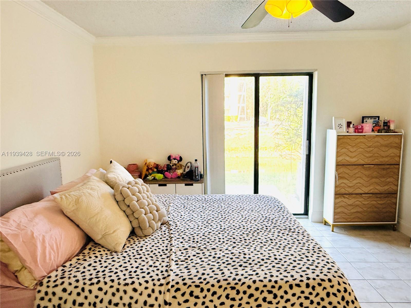 2651 Riverside Drive, Unit 3 Coral Springs, FL 33065 - Photo 15 of 29 a bedroom with a bed and painting on the wall