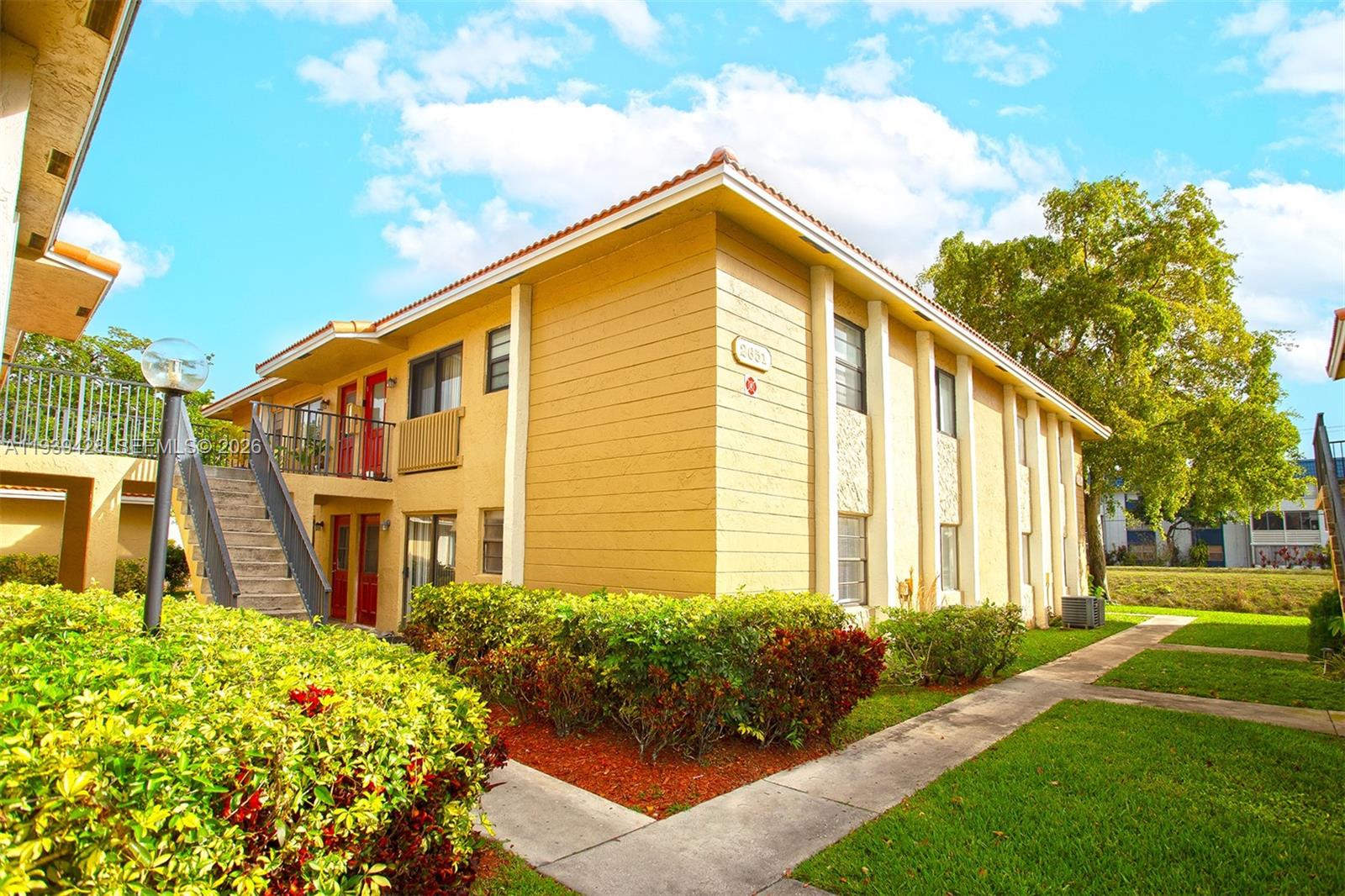 2651 Riverside Drive, Unit 3 Coral Springs, FL 33065 - Photo 2 of 29 a front view of a house with garden