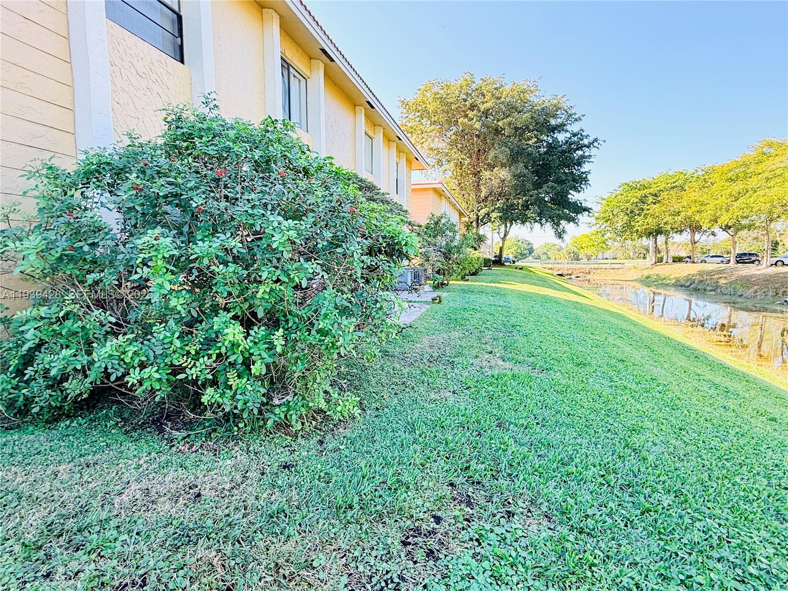 2651 Riverside Drive, Unit 3 Coral Springs, FL 33065 - Photo 22 of 29 a view of a garden with a building