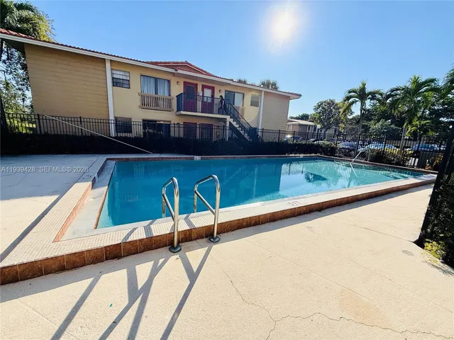a view of swimming pool with a lounge chairs