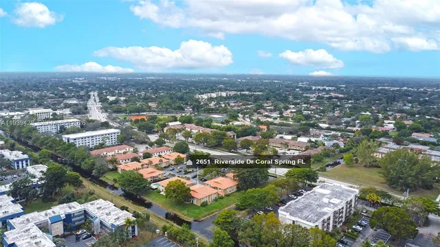 an aerial view of residential houses with city view