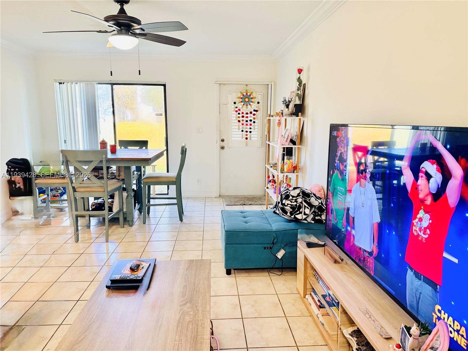 2651 Riverside Drive, Unit 3 Coral Springs, FL 33065 - Photo 7 of 29 a living room with furniture and a chandelier