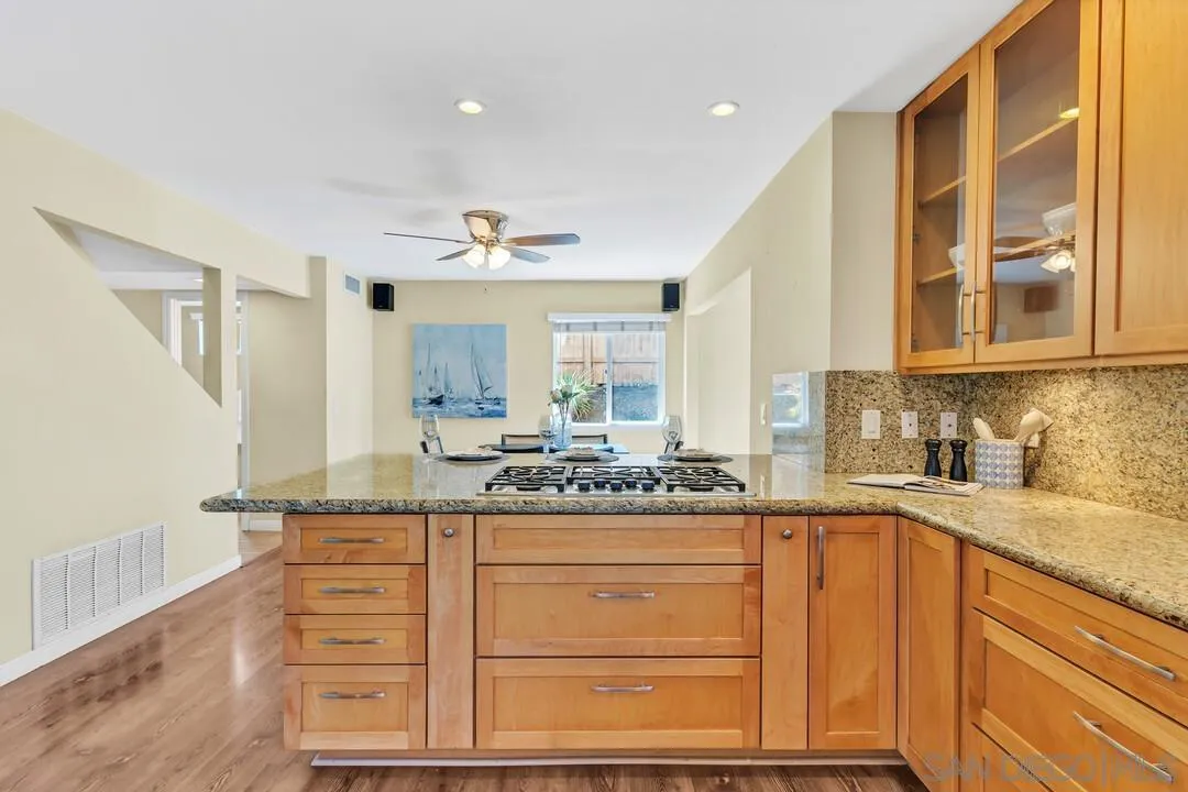 12232 Colony Drive Poway, CA 92064 - Photo 13 of 61 a kitchen with granite countertop a sink and cabinets