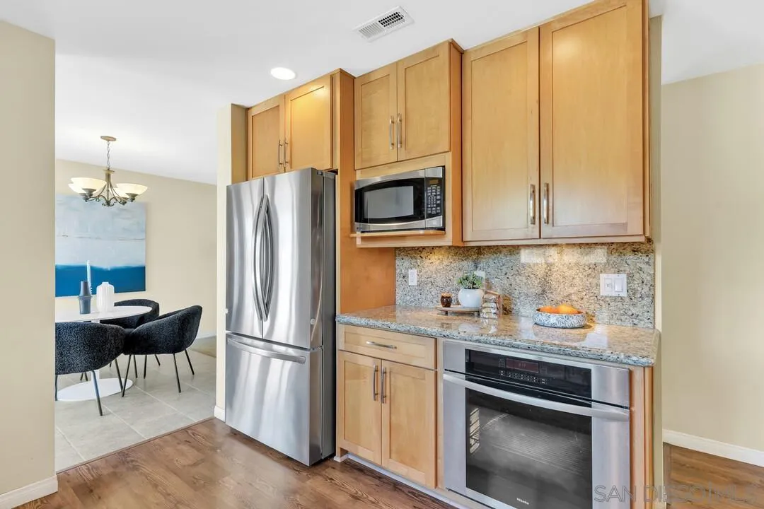 12232 Colony Drive Poway, CA 92064 - Photo 14 of 61 a kitchen with stainless steel appliances a refrigerator stove and microwave