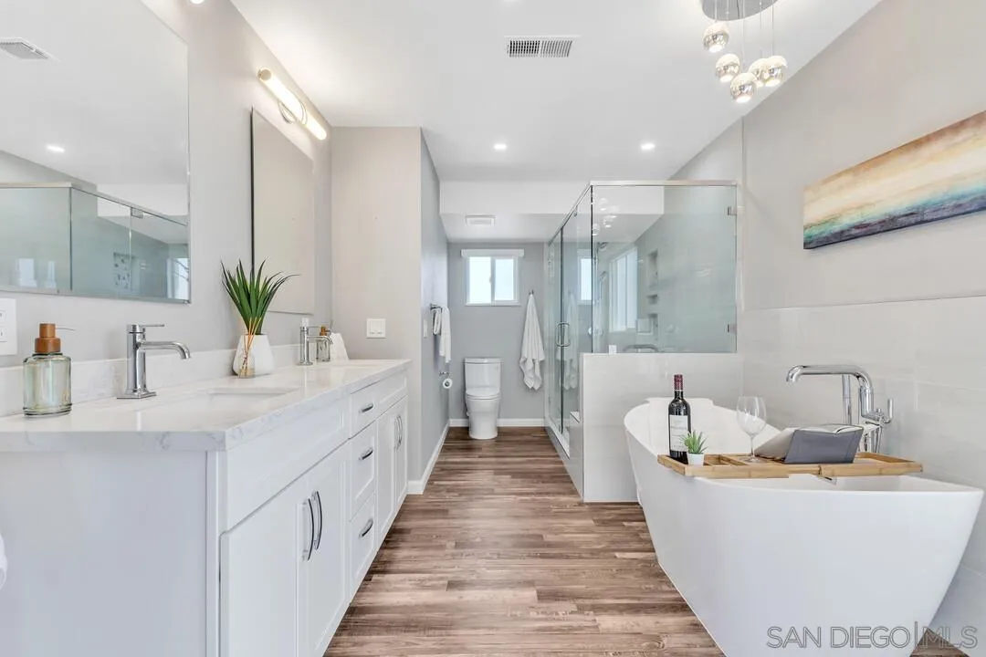 12232 Colony Drive Poway, CA 92064 - Photo 31 of 61 a spacious bathroom with a double vanity sink and a bathtub