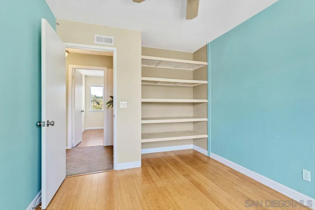 12232 Colony Drive Poway, CA 92064 - Photo 37 of 61 a view of a hallway with wooden floor and closet
