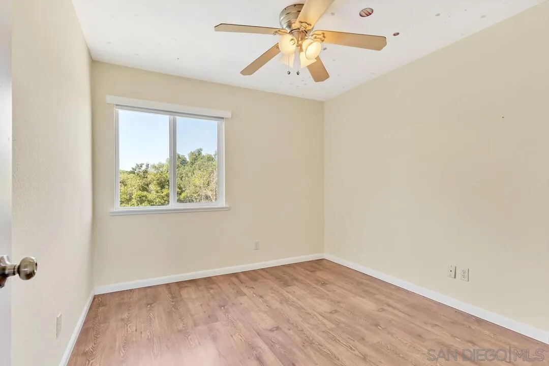 12232 Colony Drive Poway, CA 92064 - Photo 38 of 61 an empty room with a window and a ceiling fan