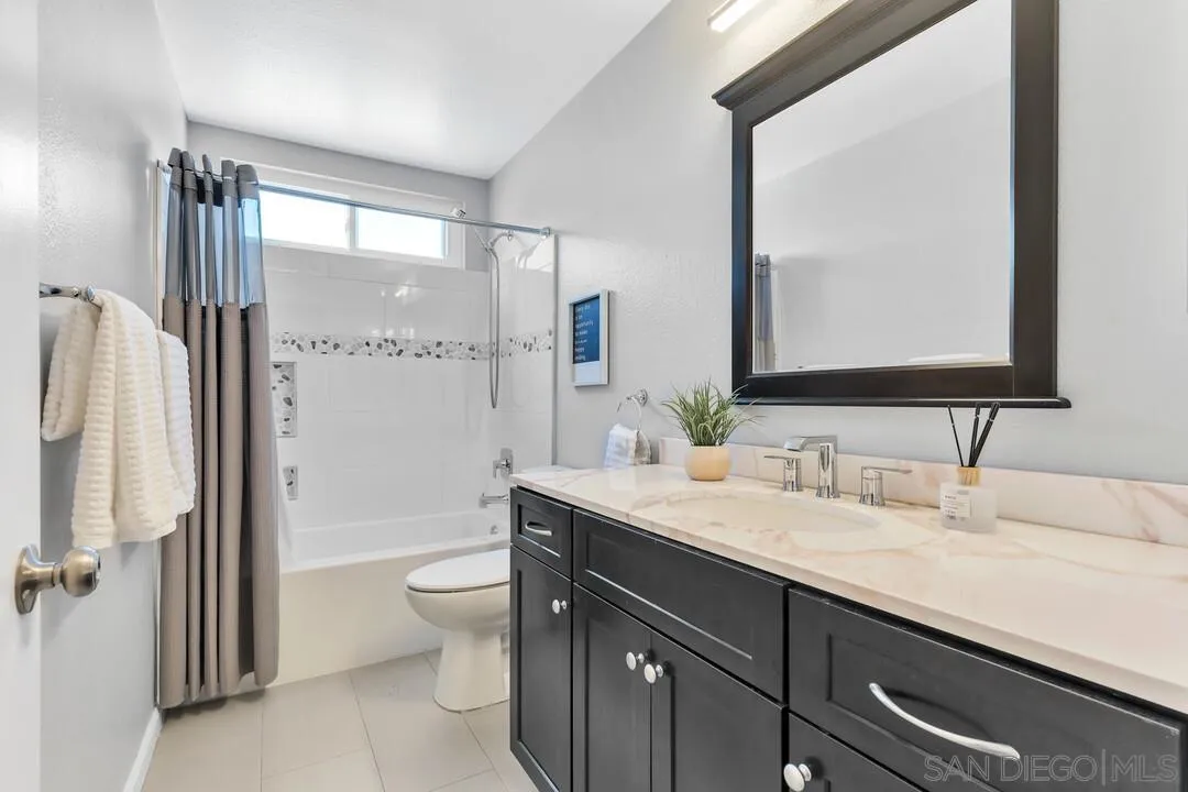 12232 Colony Drive Poway, CA 92064 - Photo 40 of 61 a bathroom with a double vanity sink toilet mirror and shower