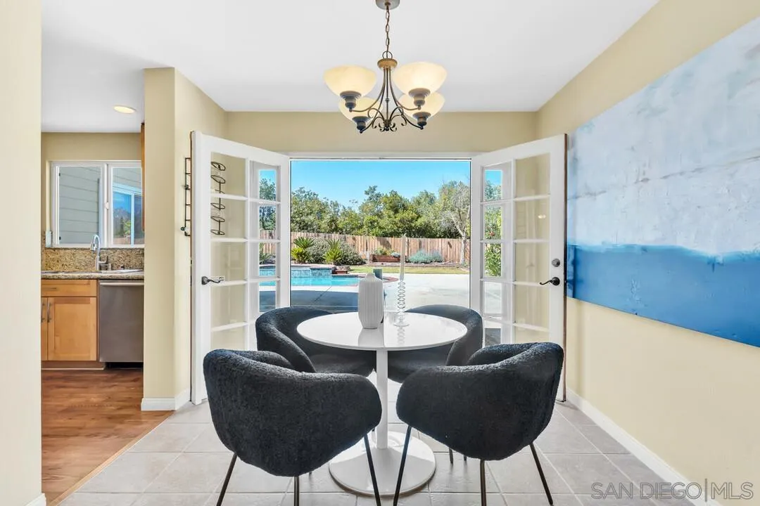 12232 Colony Drive Poway, CA 92064 - Photo 8 of 61 a dining room with furniture a chandelier and wooden floor