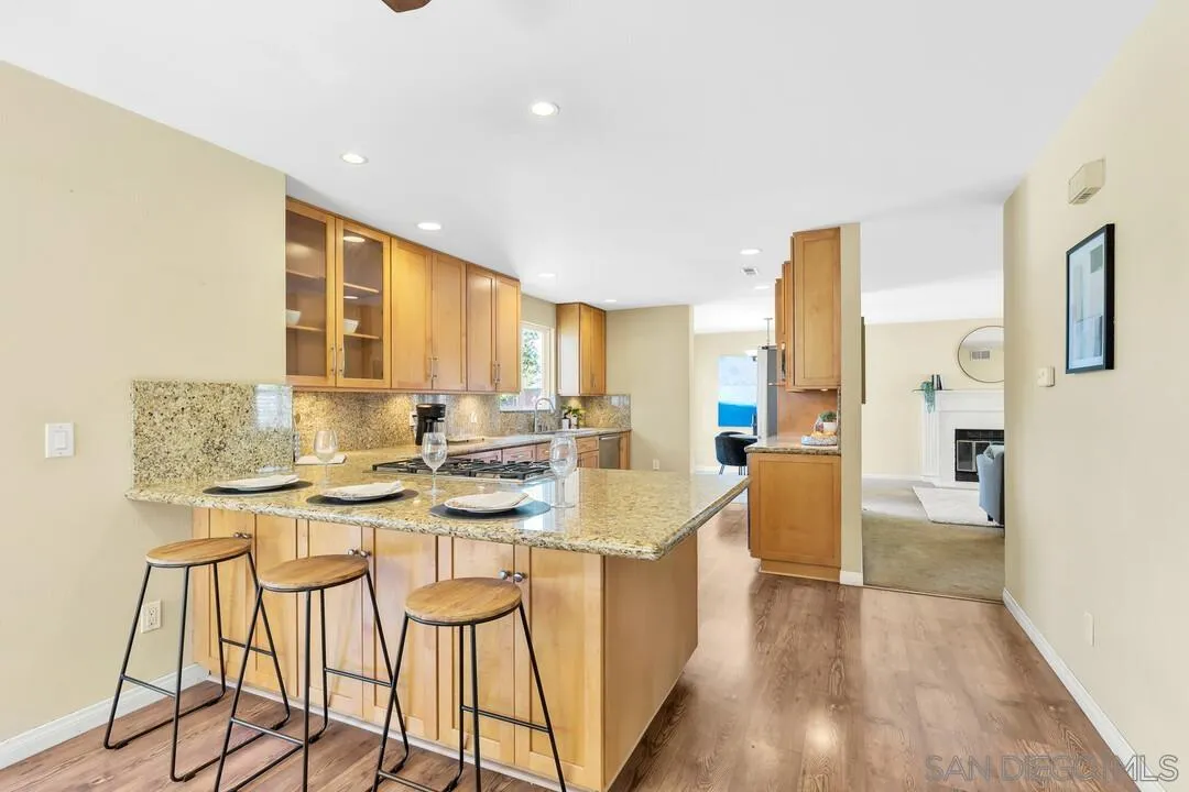 12232 Colony Drive Poway, CA 92064 - Photo 9 of 61 a kitchen with stainless steel appliances kitchen island granite countertop a sink and cabinets