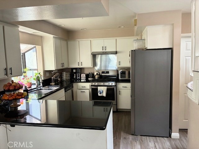 2249 Montrose Avenue, Unit 7 Montrose, CA 91020 - Photo 16 of 54 a kitchen with stainless steel appliances granite countertop a refrigerator a stove a sink and a microwave