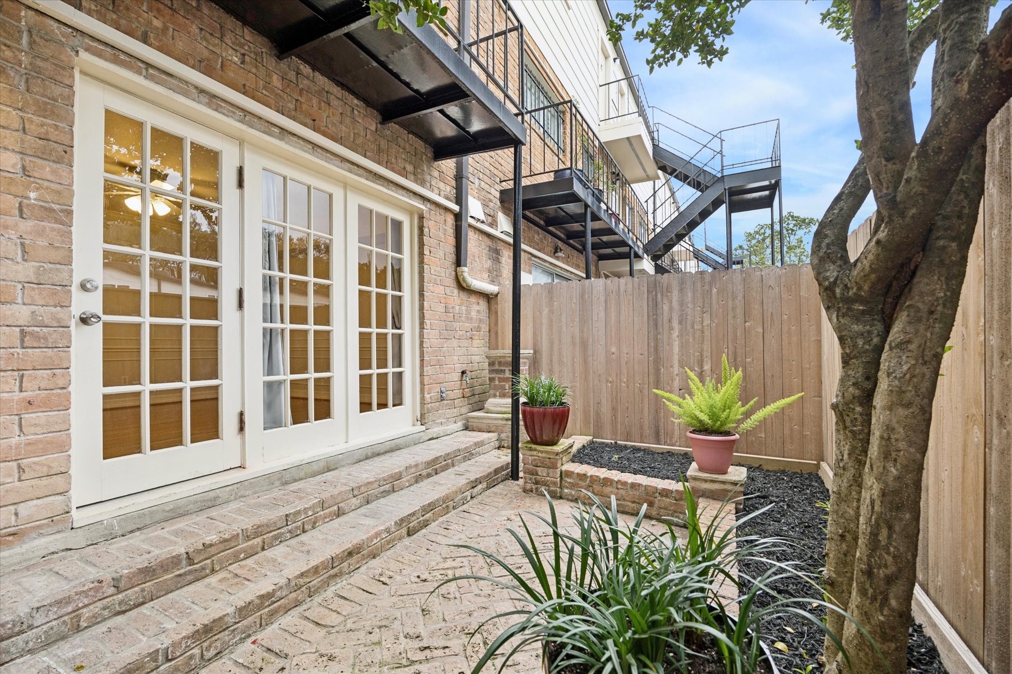 449 North Post Oak Lane, Unit 449 Houston, TX 77024 - Photo 13 of 18 Private patio off primary bedroom.