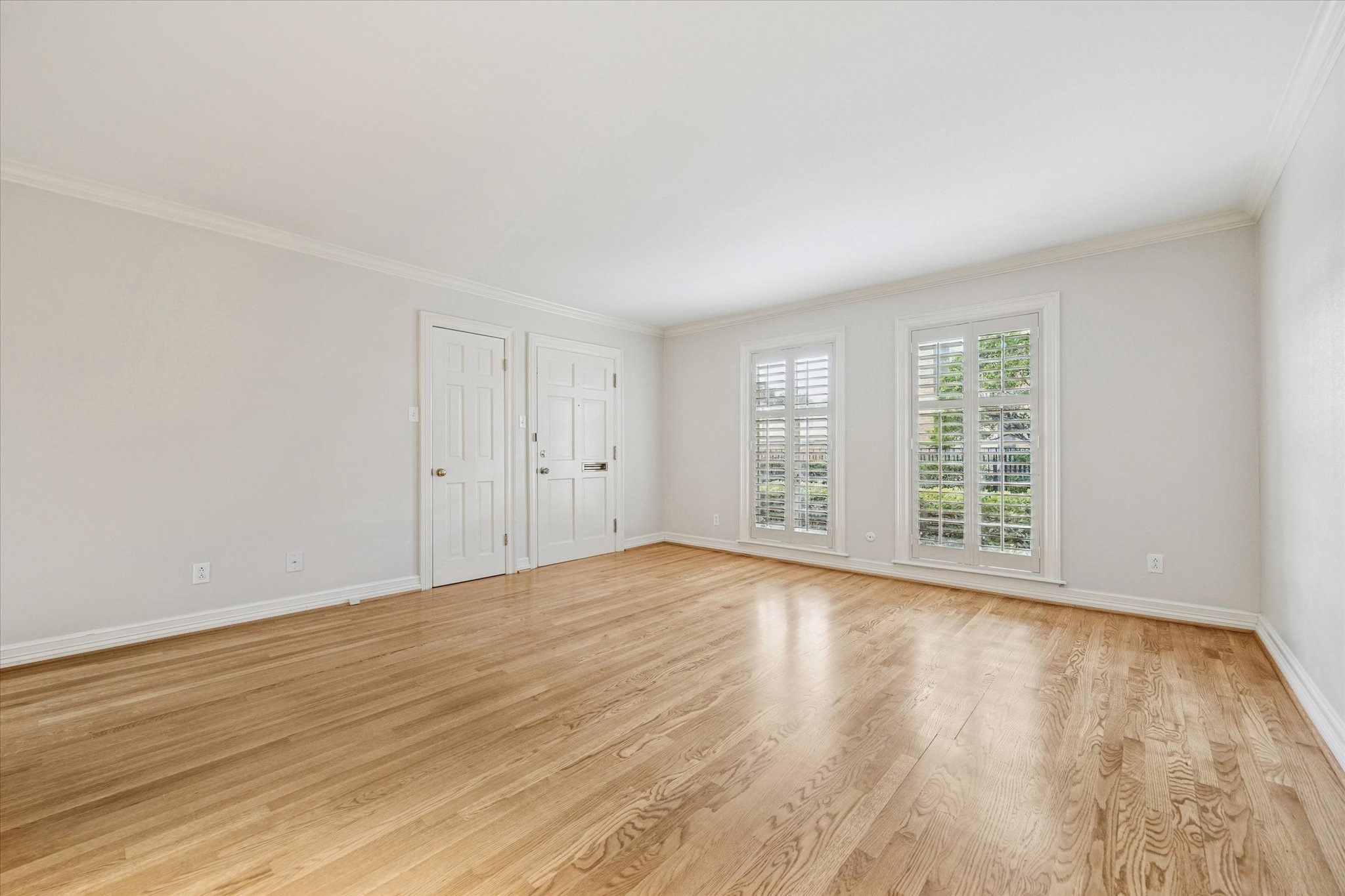 449 North Post Oak Lane, Unit 449 Houston, TX 77024 - Photo 3 of 18 Living room with hardwood floors, crown moldings and plantation shutters. The condo is vacant and ready for move-in.