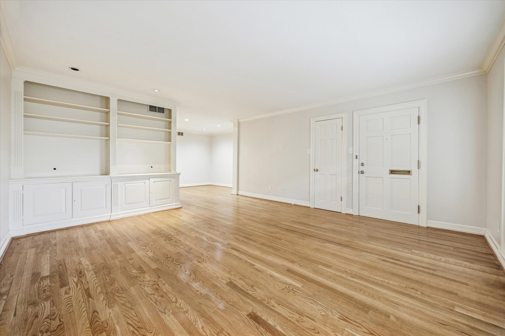 449 North Post Oak Lane, Unit 449 Houston, TX 77024 - Photo 4 of 18 Another view of the living area looking into dining room. Custom built-in bookshelves. Quiet garden court community on North Post Oak Lane. Ground floor unit.