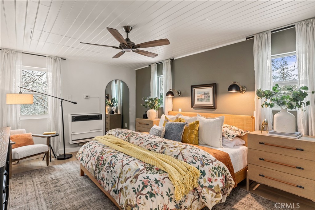 1149 Scenic Way Twin Peaks, CA 92391 - Photo 12 of 31 a bedroom with a large bed and a chandelier