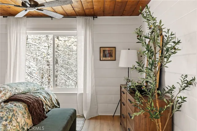 a bed sitting in a bedroom next to a window