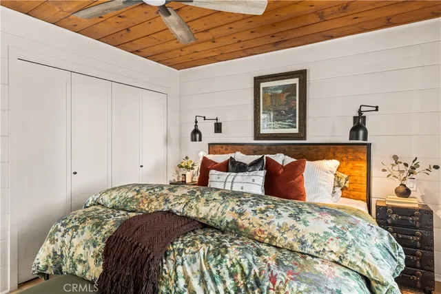 a bed sitting in a bedroom next to a window