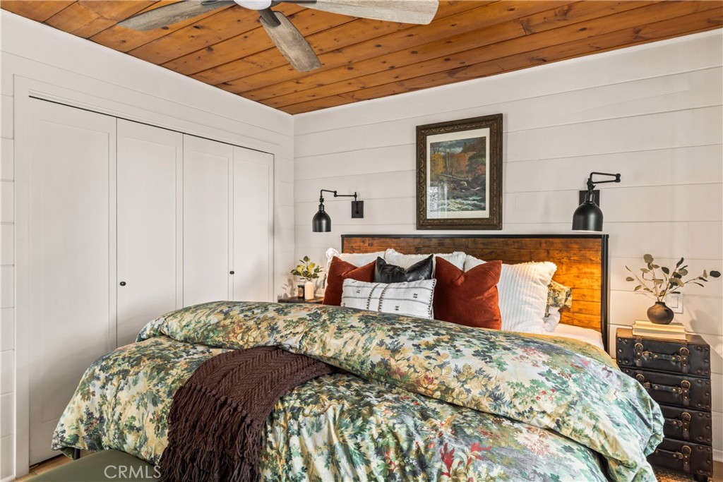 1149 Scenic Way Twin Peaks, CA 92391 - Photo 22 of 31 a bed sitting in a bedroom next to a window