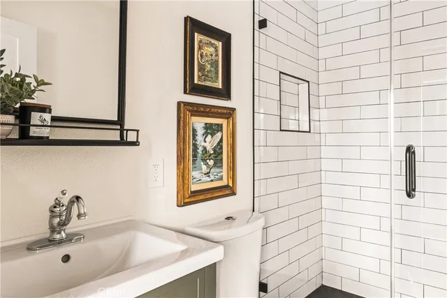 a bathroom with a sink a toilet and mirror