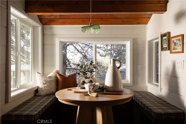 a dining room with furniture window and wooden floor