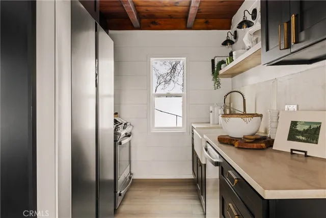a kitchen with a refrigerator and a stove top oven