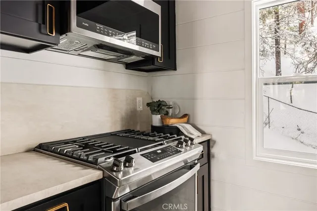 a stove top oven sitting inside of a kitchen