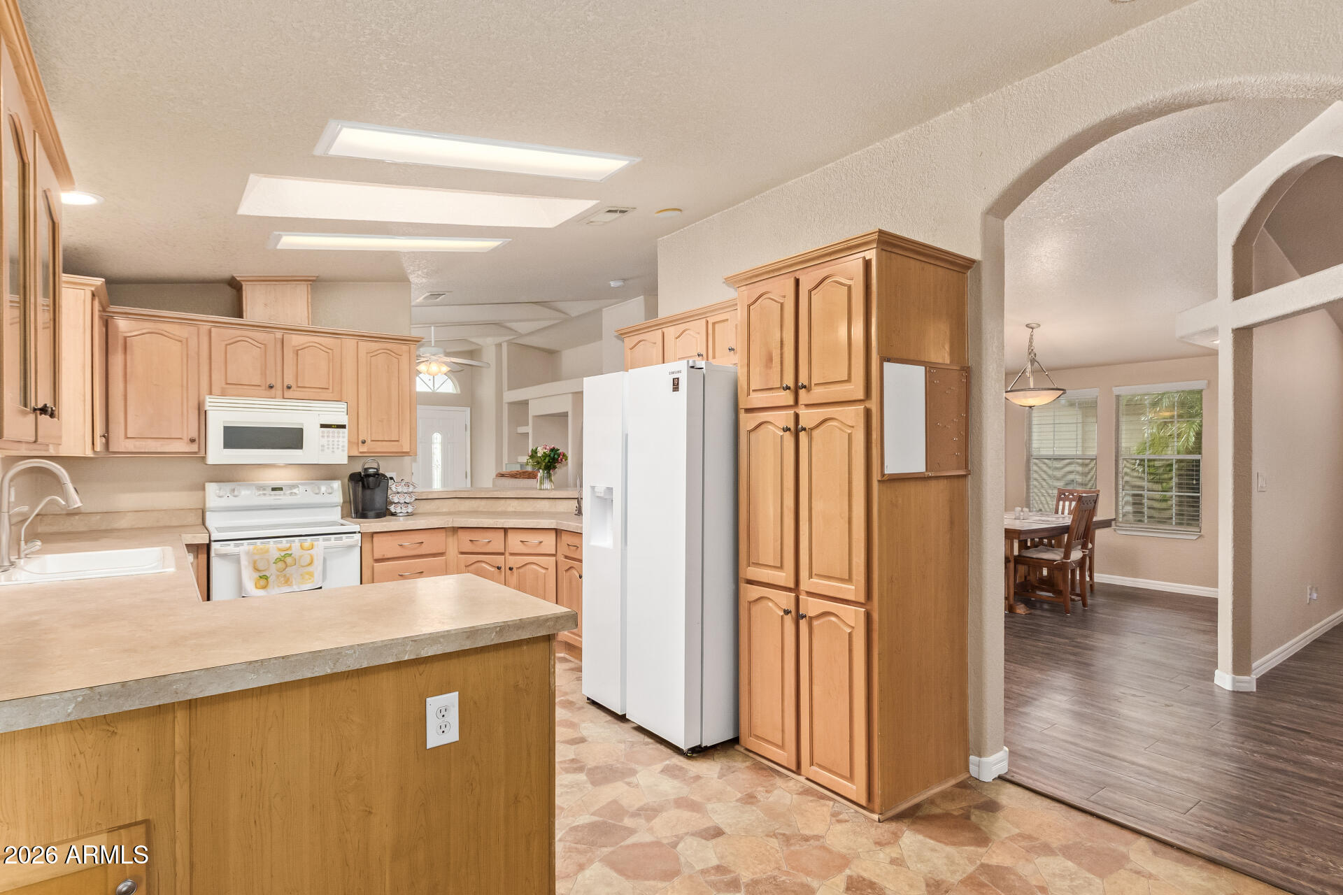 3301 South Goldfield Road, Unit 4028 Apache Junction, AZ 85119 - Photo 4 of 43 a kitchen with stainless steel appliances granite countertop a refrigerator and a sink