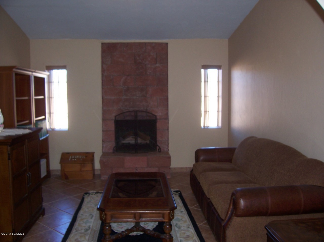791 Camino Loma Rio Rico, AZ 85648 - Photo 2 of 13 a living room with furniture and a fireplace