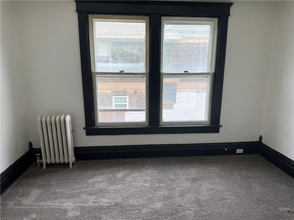 41 West Ridge Street Lansford, PA 18232 - Photo 21 of 40 Well-lit room features soft carpeting and classic windows, creating a versatile living space.
