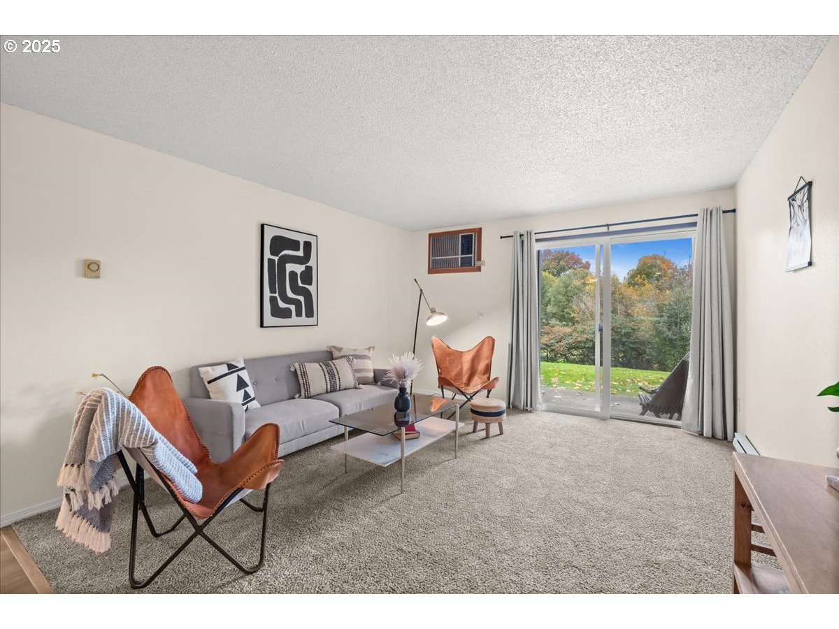 12612 Northwest Barnes Road, Unit 6 Portland, OR 97229 - Photo 11 of 40 a living room with furniture and a floor to ceiling window