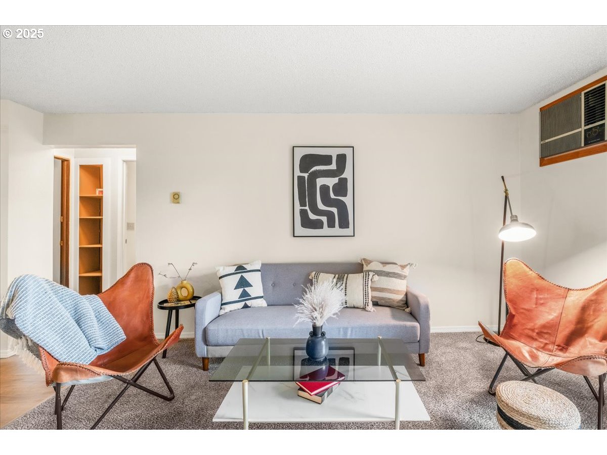 12612 Northwest Barnes Road, Unit 6 Portland, OR 97229 - Photo 12 of 40 a living room with furniture and a chair